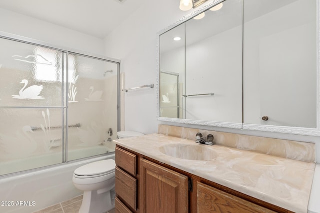 full bathroom featuring tile patterned flooring, toilet, vanity, and bath / shower combo with glass door