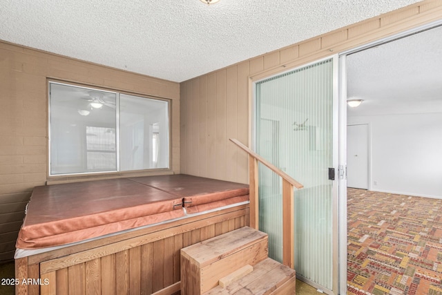 stairs with baseboards and a textured ceiling
