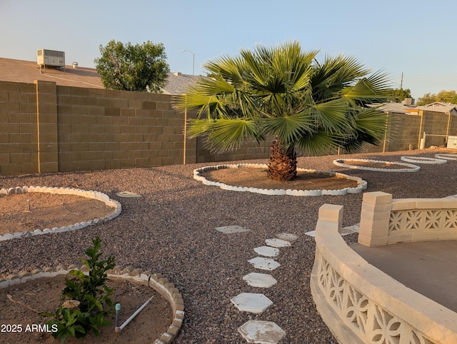 view of yard featuring central air condition unit and fence