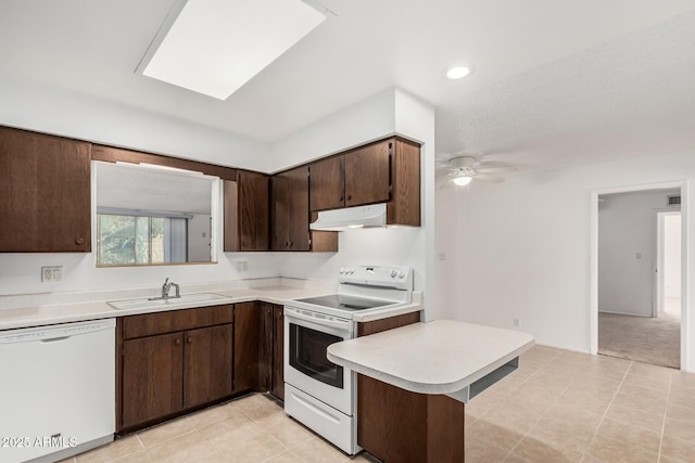 kitchen with white appliances, light countertops, under cabinet range hood, ceiling fan, and a sink
