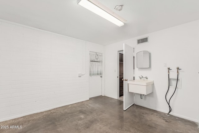 interior space featuring visible vents, vanity, and finished concrete flooring
