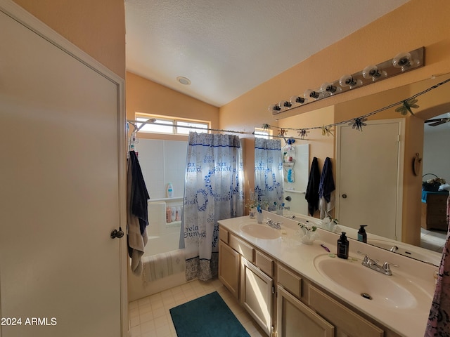 bathroom featuring oversized vanity, shower / bath combination with curtain, vaulted ceiling, tile flooring, and dual sinks