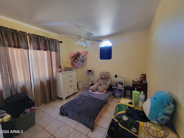 bedroom featuring ceiling fan and light tile floors