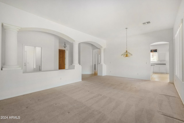 unfurnished room with light carpet and ornate columns