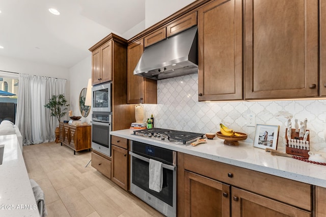 23083 N 74th Pl, Scottsdale, AZ 85255 - kitchen with under cabinet range hood, appliances with stainless steel finishes, backsplash, light stone countertops, and recessed lighting