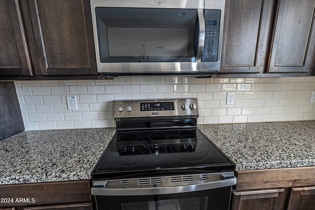 kitchen with decorative backsplash, stone countertops, dark brown cabinetry, and stainless steel appliances