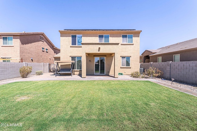 rear view of house with a patio, a lawn, and central air condition unit