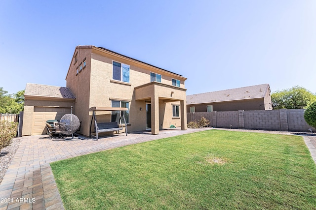 rear view of property featuring a patio and a lawn