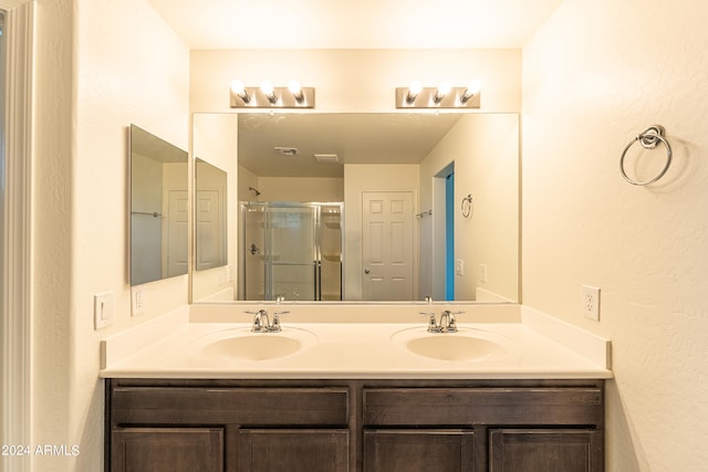 bathroom featuring walk in shower and vanity