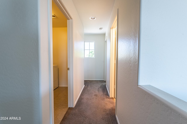 hallway with washer / clothes dryer and carpet