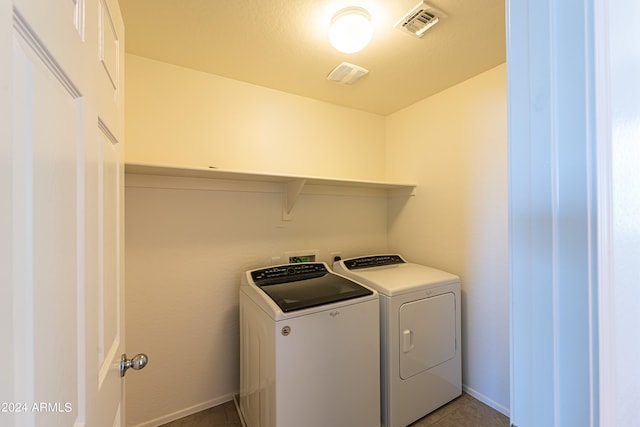 laundry room with separate washer and dryer and light tile patterned floors