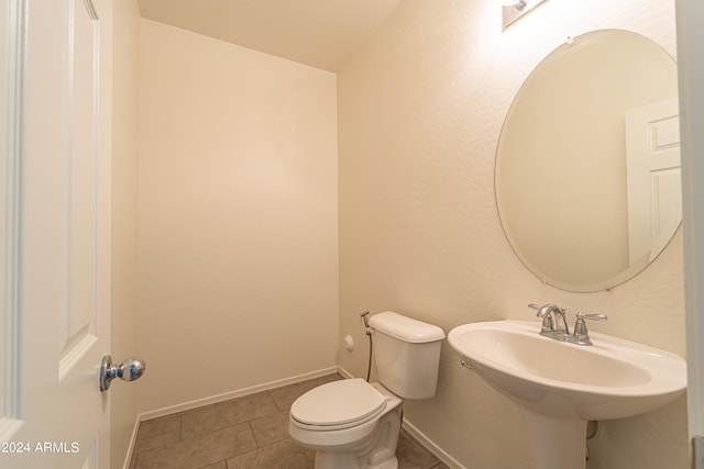 bathroom featuring tile patterned floors, toilet, and sink