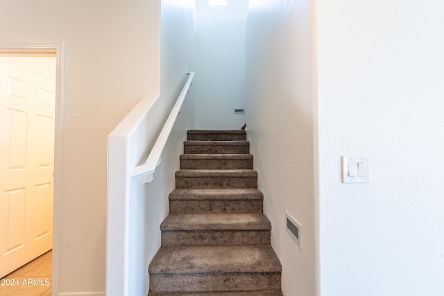 stairs featuring tile patterned flooring