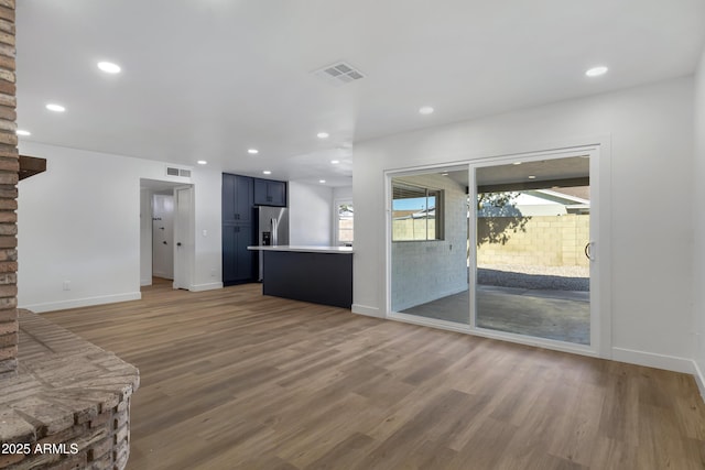 unfurnished living room featuring hardwood / wood-style floors