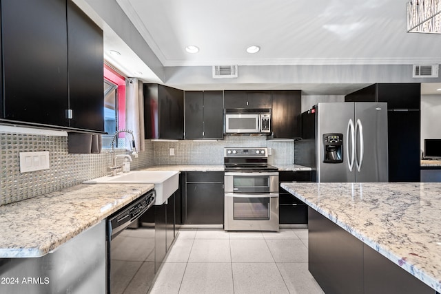 kitchen with crown molding, sink, light stone countertops, backsplash, and appliances with stainless steel finishes