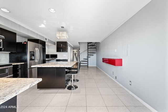 kitchen featuring stainless steel appliances, ornamental molding, a kitchen island, and a kitchen bar