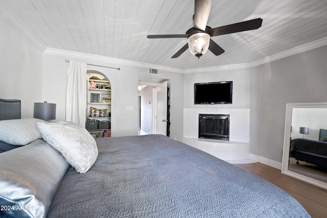 bedroom with ceiling fan, ornamental molding, wood-type flooring, and wooden ceiling