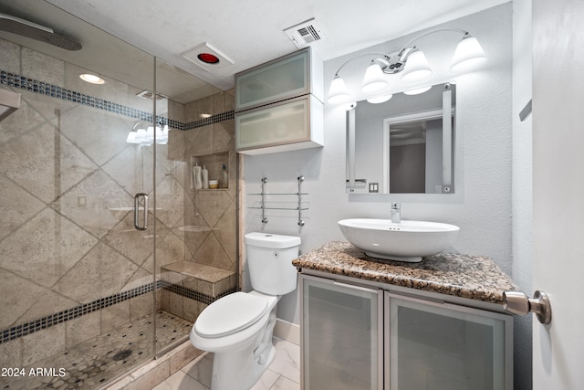 bathroom featuring an enclosed shower, vanity, and toilet