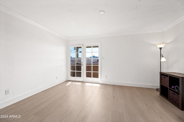 unfurnished living room with french doors, crown molding, and light hardwood / wood-style flooring