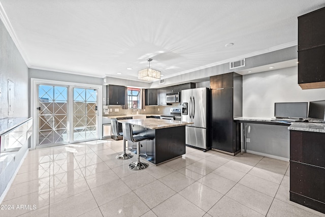 kitchen with pendant lighting, crown molding, a breakfast bar, appliances with stainless steel finishes, and a center island