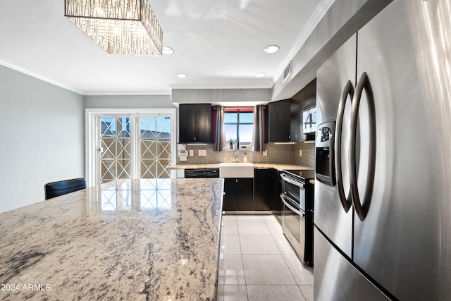 kitchen featuring light stone countertops, appliances with stainless steel finishes, backsplash, and crown molding