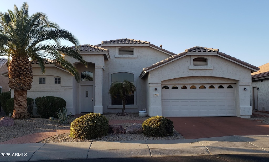 mediterranean / spanish-style home featuring a garage