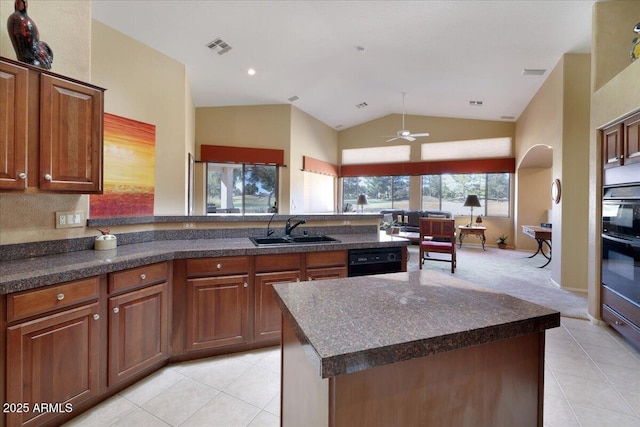 kitchen with dishwasher, a kitchen island, sink, and light tile patterned flooring