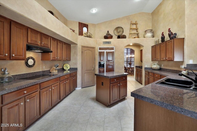 kitchen with sink, a kitchen island, high vaulted ceiling, black electric stovetop, and light tile patterned flooring