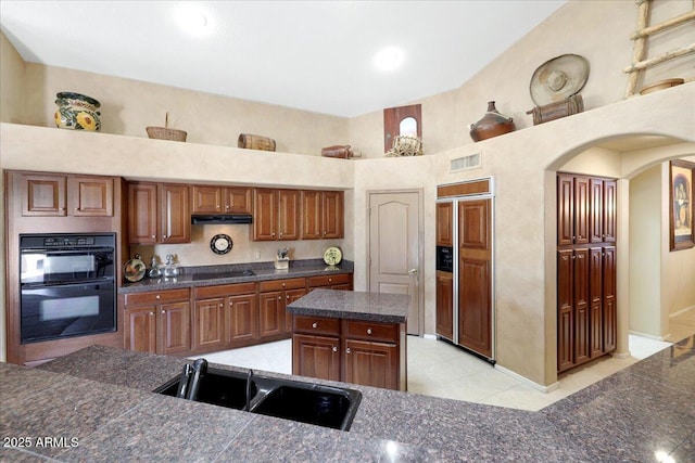 kitchen with a center island, sink, and black appliances