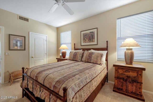 bedroom featuring light carpet and ceiling fan