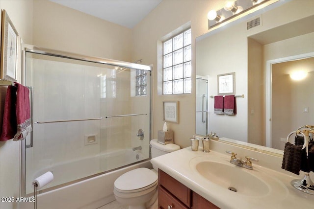 full bathroom with toilet, vanity, and bath / shower combo with glass door