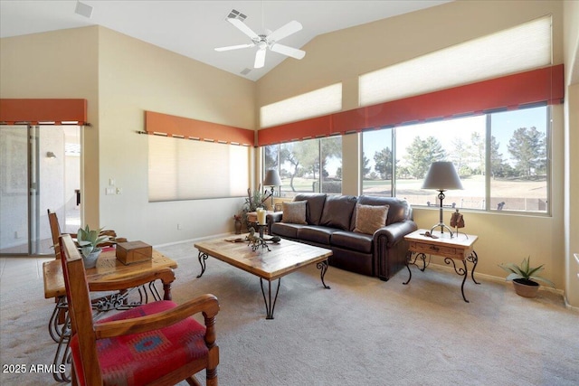 carpeted living room with ceiling fan, lofted ceiling, and plenty of natural light