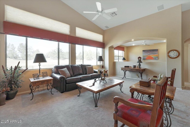 living room with high vaulted ceiling, light colored carpet, and ceiling fan