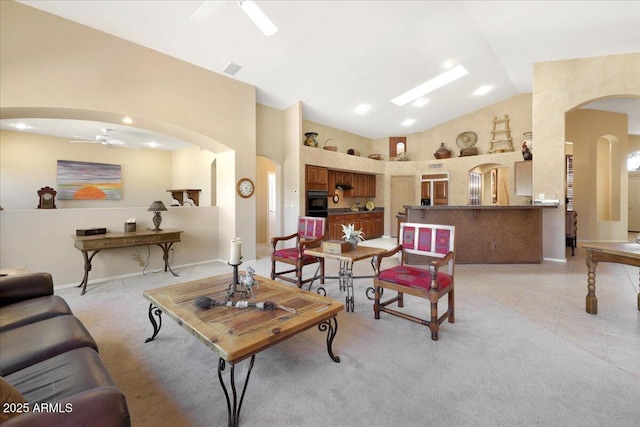 tiled living room featuring high vaulted ceiling and ceiling fan