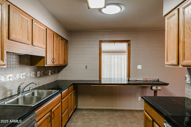 kitchen featuring sink, decorative backsplash, light tile patterned floors, and dishwasher