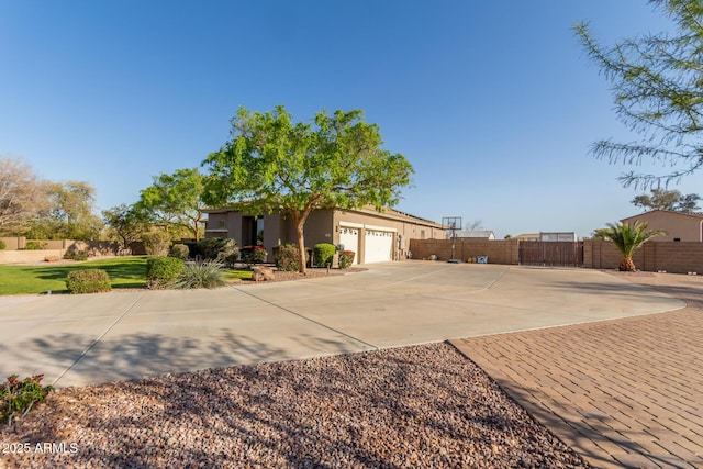 18927 W Mitchell Ct, Litchfield Park, AZ 85340 - view of property exterior featuring stucco siding, driveway, fence, and an attached garage