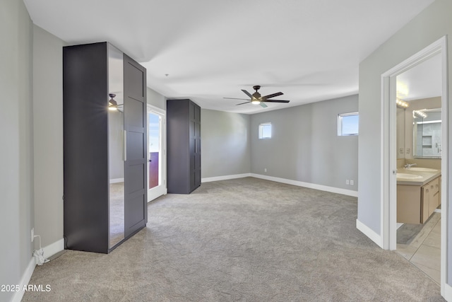 unfurnished room with ceiling fan and light colored carpet