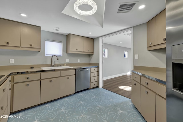 kitchen featuring appliances with stainless steel finishes, sink, and cream cabinets