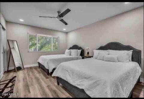 bedroom with hardwood / wood-style floors and ceiling fan