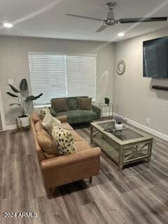 living room featuring wood-type flooring and ceiling fan