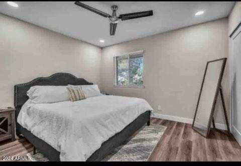 bedroom featuring dark wood-type flooring and ceiling fan