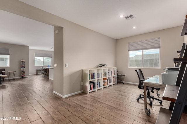 office space with baseboards, recessed lighting, visible vents, and light wood-style floors