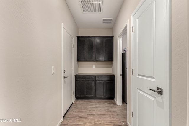 hall with light wood-type flooring and visible vents