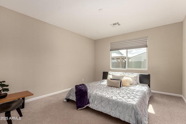 carpeted bedroom with visible vents and baseboards