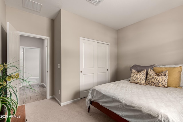 carpeted bedroom featuring visible vents and baseboards