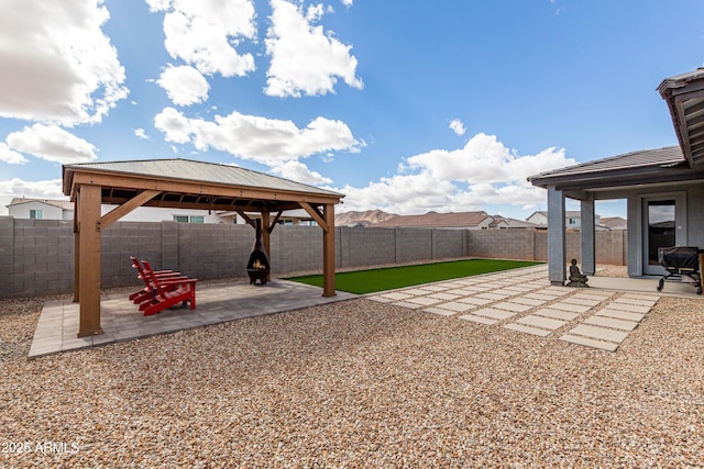 view of yard featuring a patio area, a fenced backyard, and a gazebo