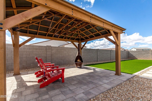 view of patio featuring a gazebo, an outdoor fire pit, and a fenced backyard