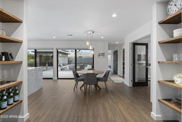 dining area featuring dark wood-type flooring