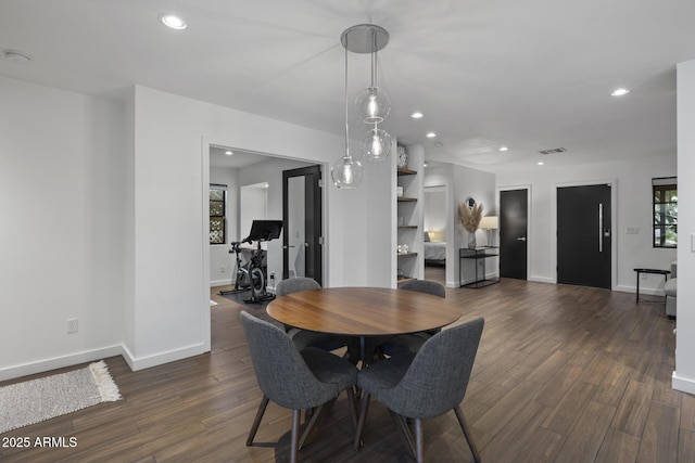 dining area with dark hardwood / wood-style floors