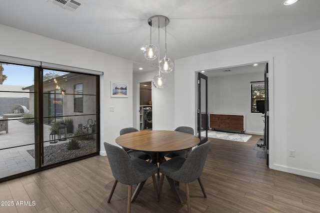 dining area featuring washer / clothes dryer and wood-type flooring